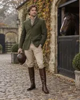 AI illustration of a European man in equestrian-inspired tailoring beside a manor stable courtyard. — AI style illustration