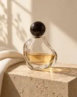 AI illustration of an unlabelled sculptural glass perfume bottle on limestone with soft studio light; no people are present.